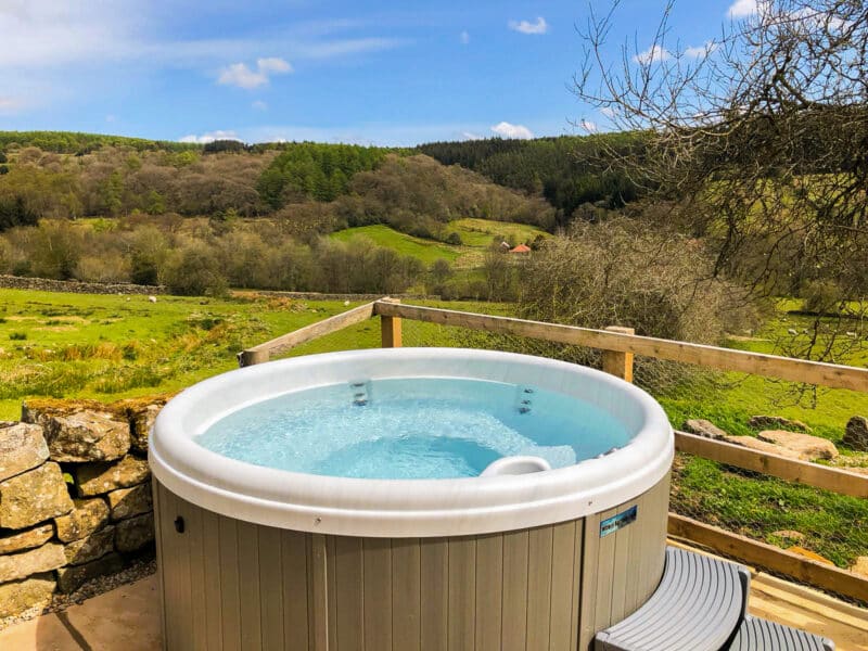 Impulse DP round hot tub filled with water - outdoor hot tub for UK homes and gardens - Balboa hot tub
