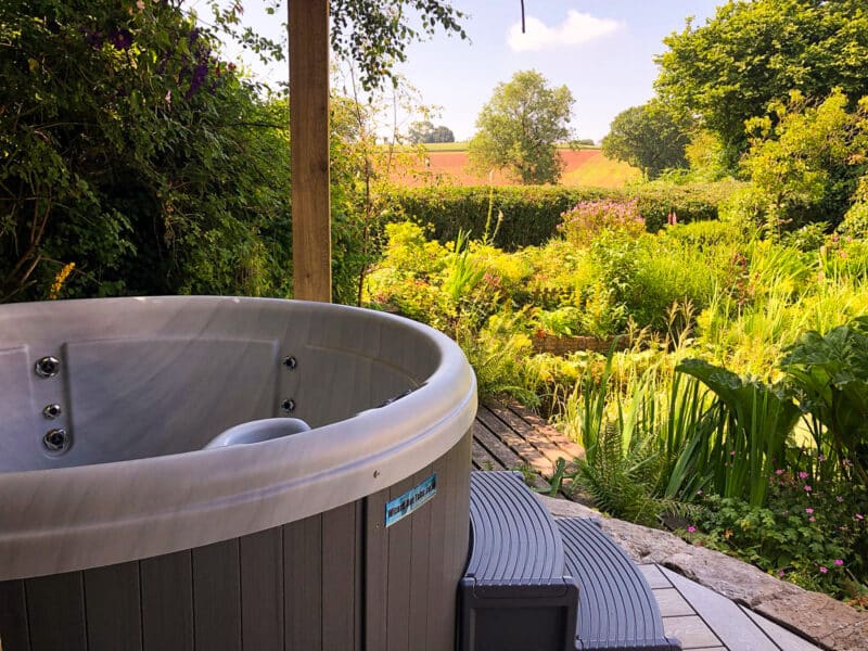 Impulse DP round hot tub in landscaped UK garden - stylish 5 person hot tub for outdoor relaxation